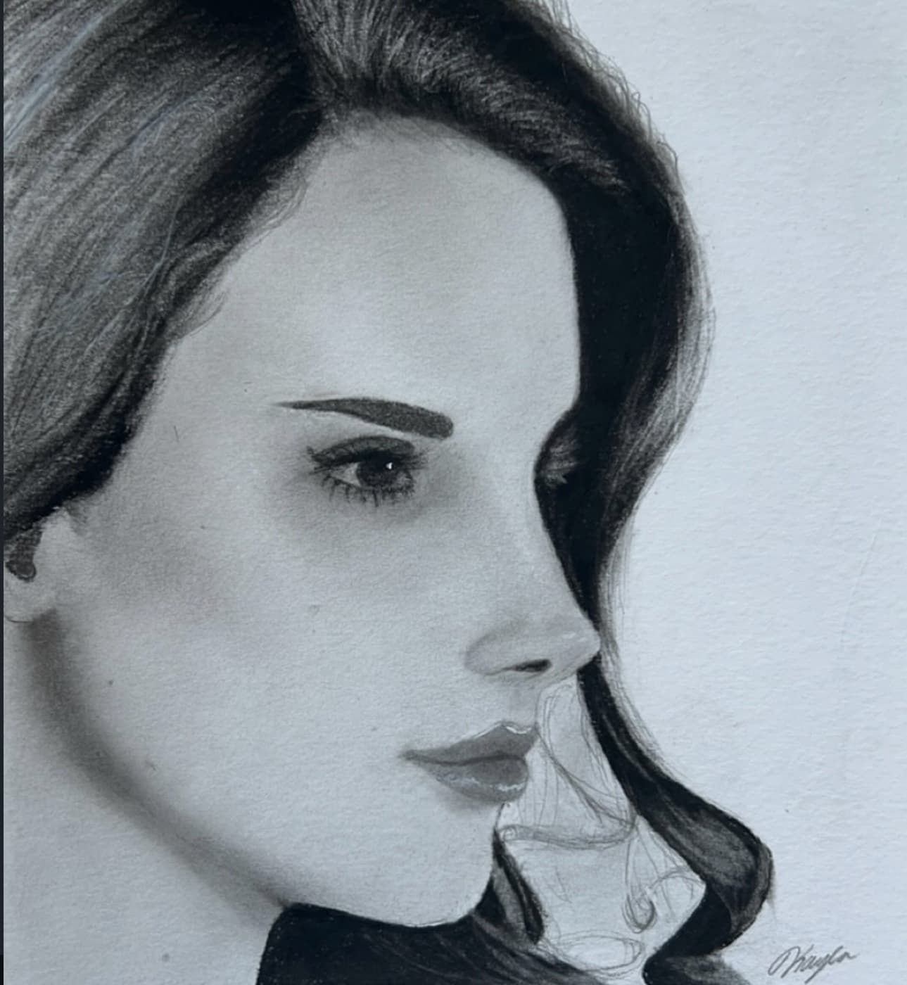 Graphite profile portrait of a woman with voluminous waved hair.