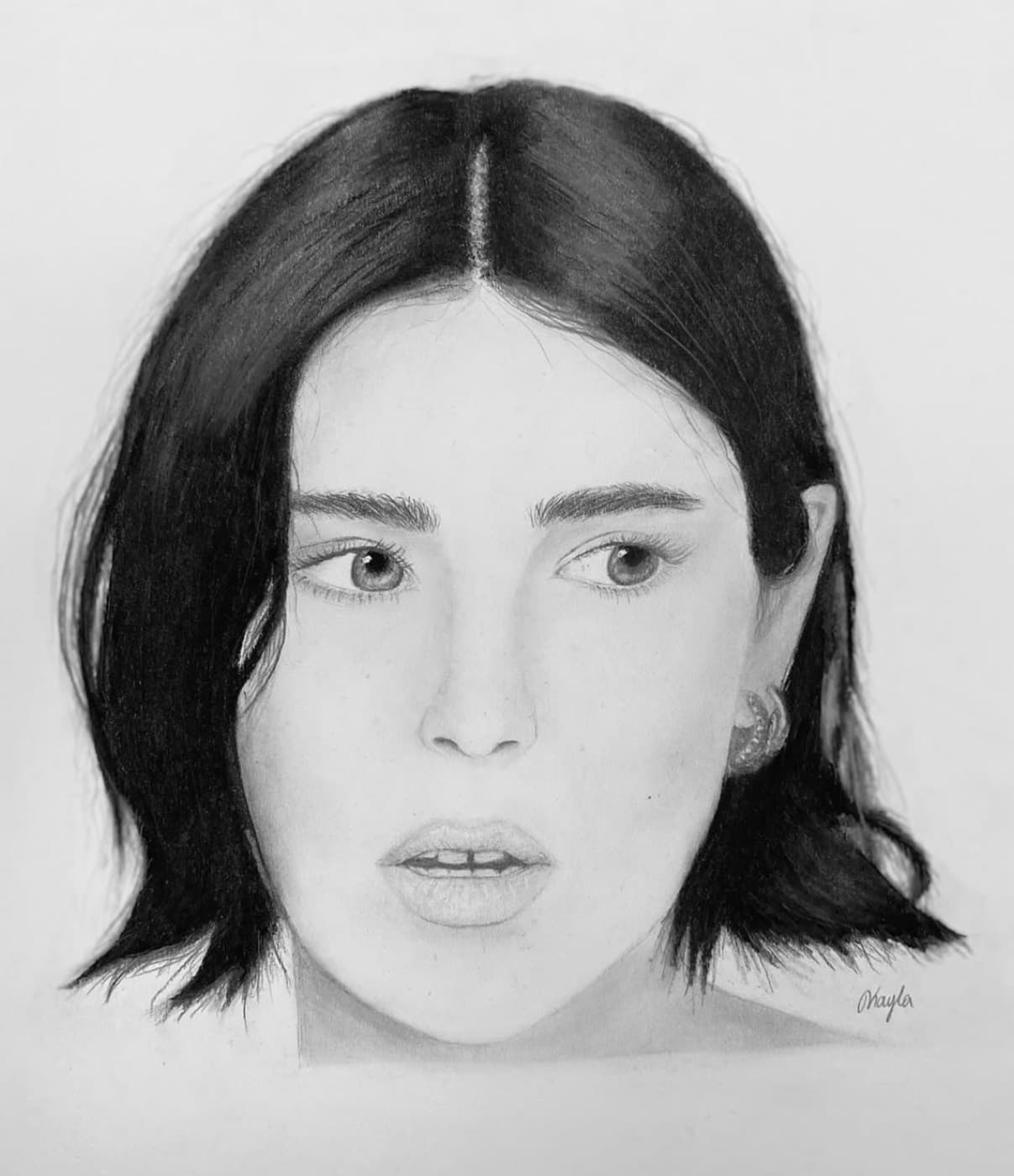 Graphite portrait of a woman with dark shoulder-length hair, lips parted mid-expression.