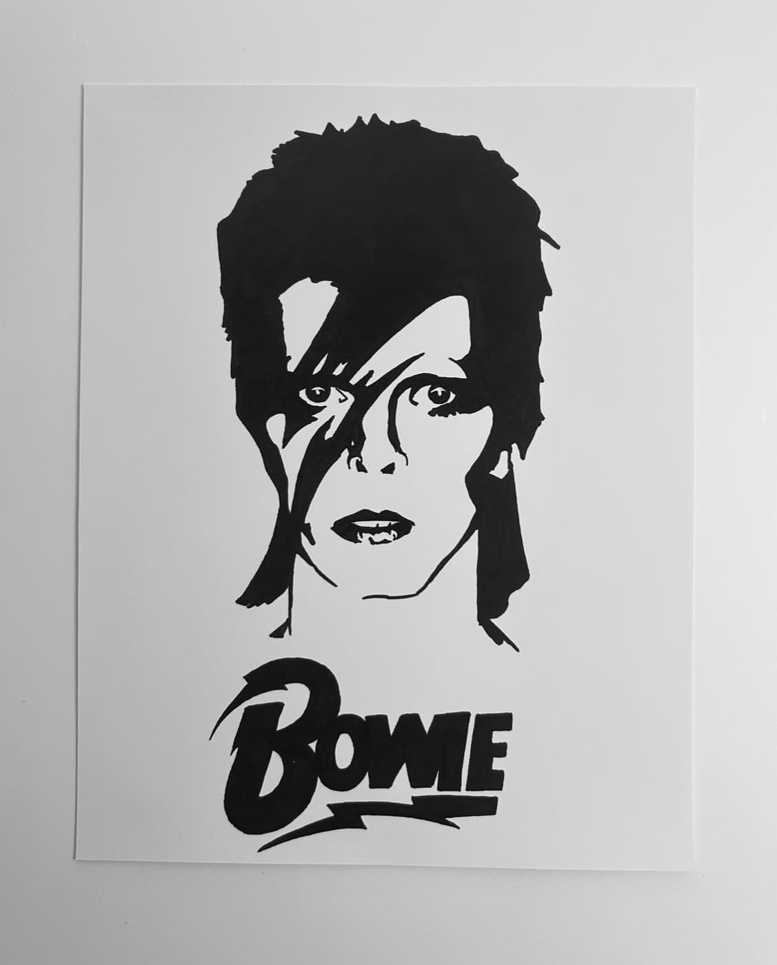 Black ink portrait of David Bowie with the Aladdin Sane lightning bolt and hand-lettered Bowie logo.