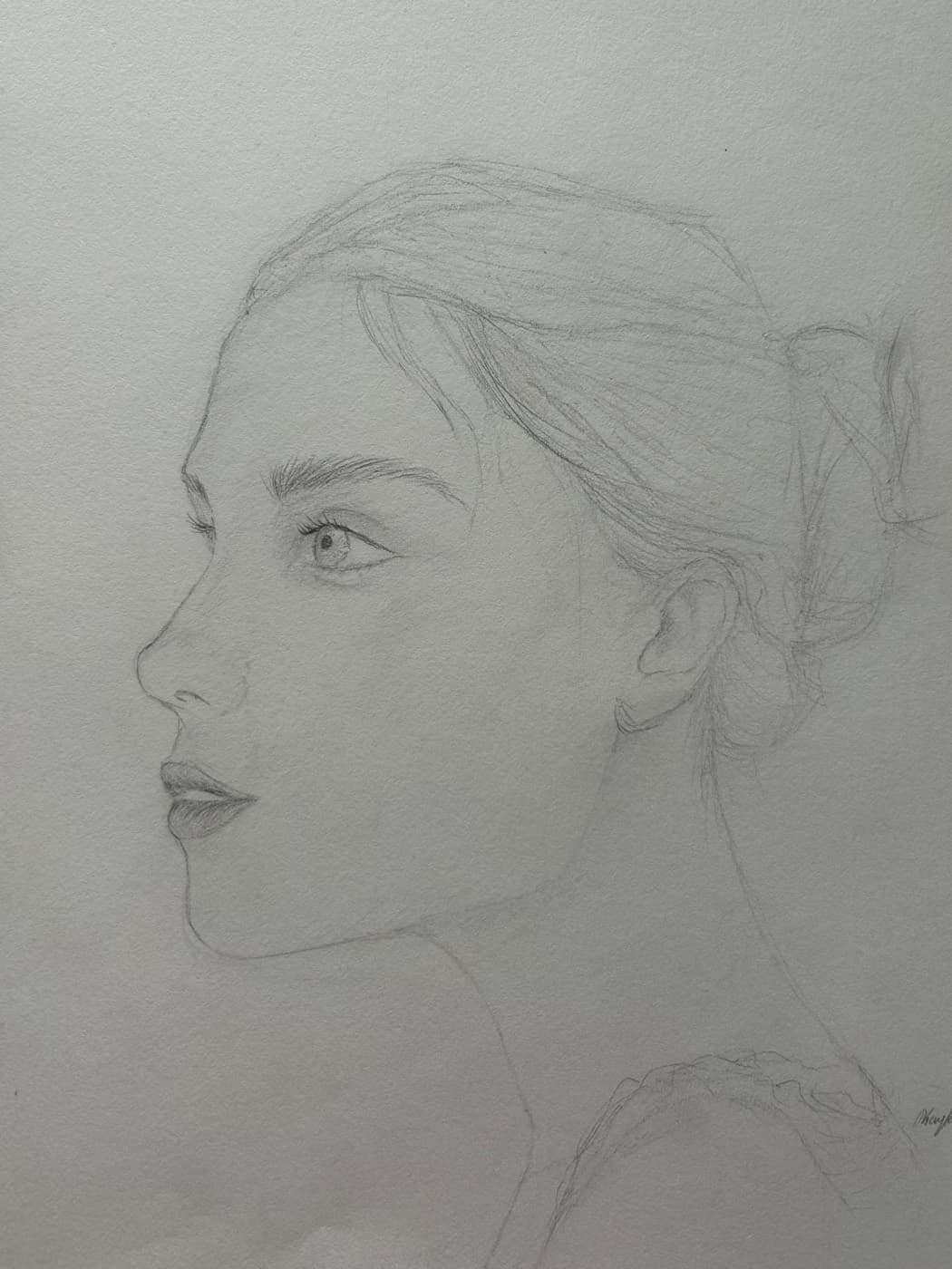 Pencil sketch of a woman in profile with her hair pulled into a bun.