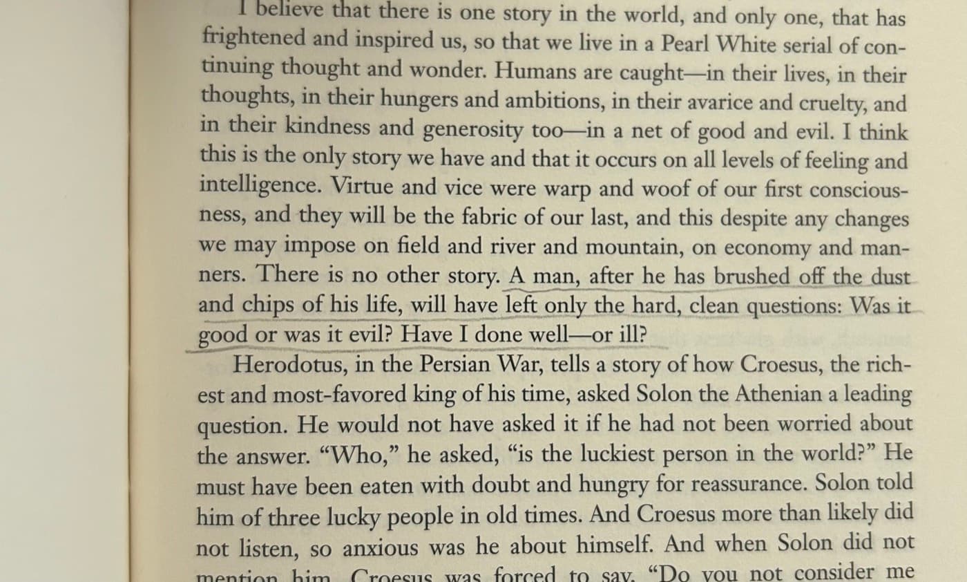 Book page from East of Eden with a passage about the hard, clean questions underlined in pencil.